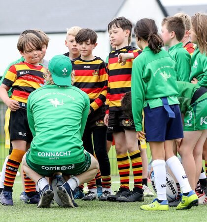 A coach talks to some of the children taking part in the summer camp 1/7/2021
